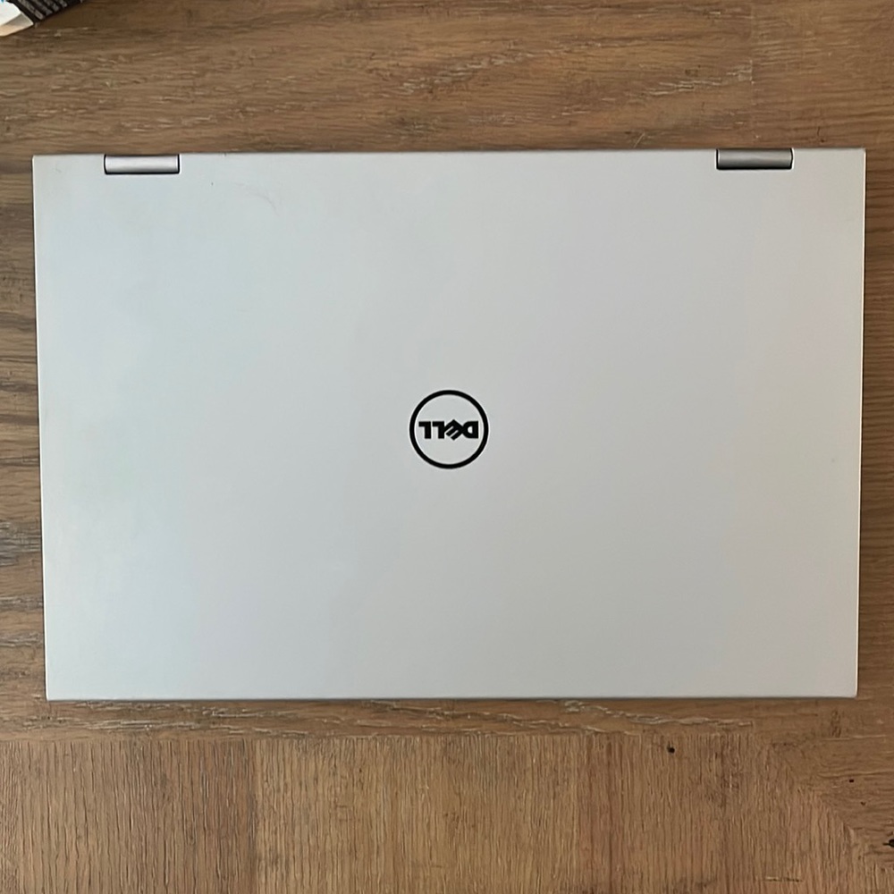 Silver Dell laptop that folds over to a tablet